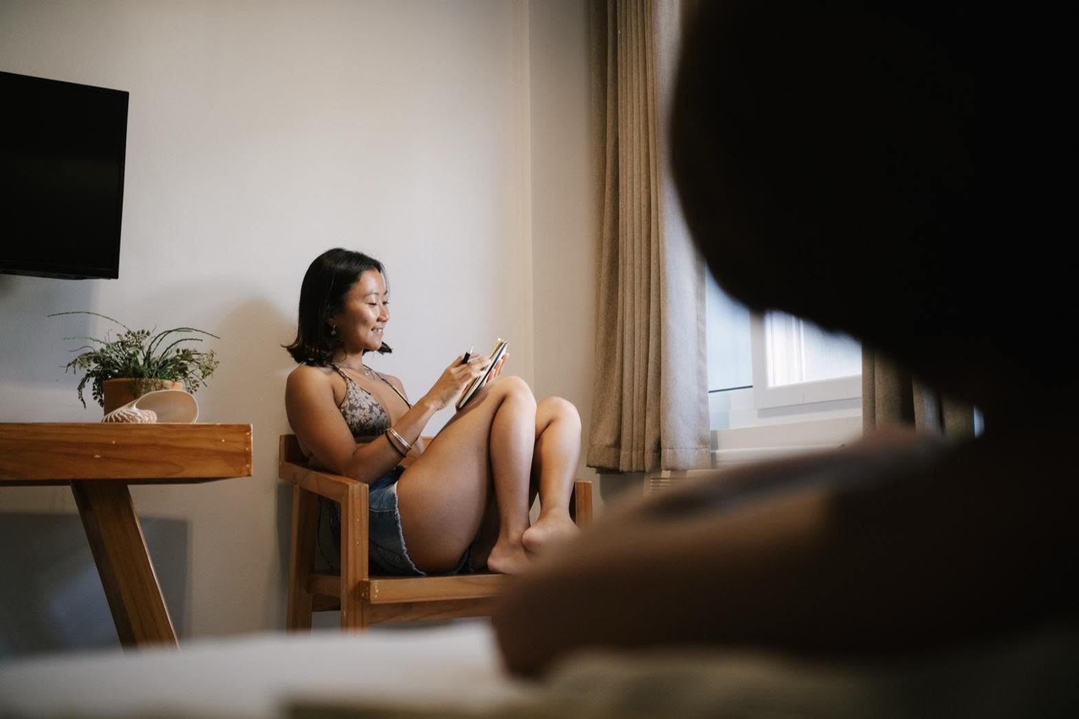 A guest relaxing in her room, typing on her phone